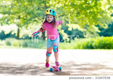 Child riding skateboard in summer park Child riding skateboard in summer park 31047036