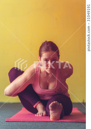 Young woman performing yoga in class 31049191