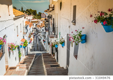 Picturesque street of Mijas with flower pots 31049476