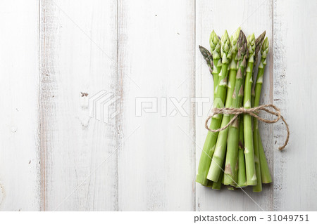 Bunch of fresh asparagus on wooden table 31049751