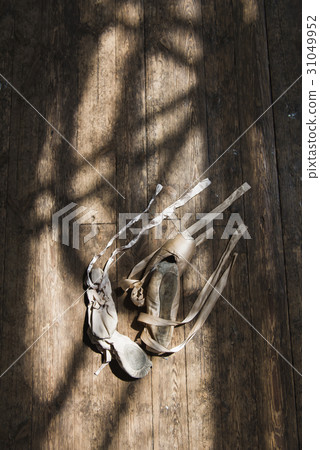 Old ballet shoes on old wooden floor. 31049952