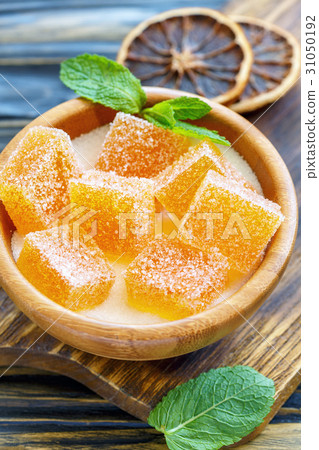 Homemade orange marmalade in a wooden bowl. Homemade orange marmalade in a wooden bowl. 31050192