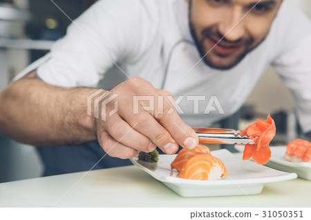 Man japanese restaurant chef cooking in the Man japanese restaurant chef cooking in the 31050351