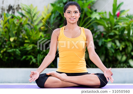 Young woman practicing yoga in lotus position Young woman practicing yoga in lotus position 31050560