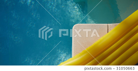 yellow air mattress swimming in a shiny blue swimm yellow air mattress swimming in a shiny blue swimm 31050663