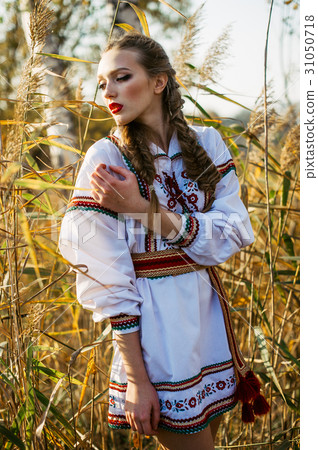 Young girl on the summer field in national clothes Young girl on the summer field in national clothes 31050718