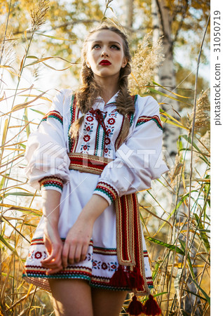 Young girl on the summer field in national clothes 31050719