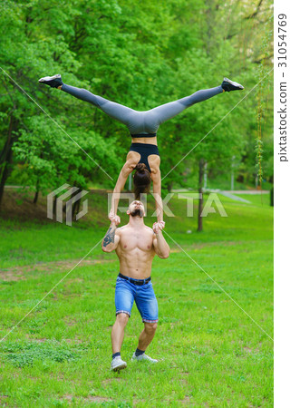A guy and a girl are doing sports, aerial A guy and a girl are doing sports, aerial 31054769