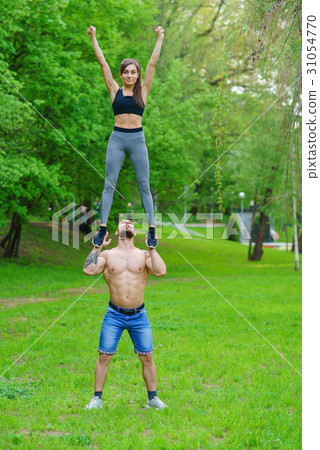 A guy and a girl are doing sports, aerial A guy and a girl are doing sports, aerial 31054770