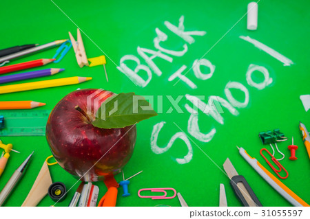 School supplies on Green chalkboard " Back to school background " . 31055597