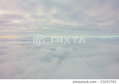 Sunrise above clouds from airplane window . Sunrise above clouds from airplane window . 31055783