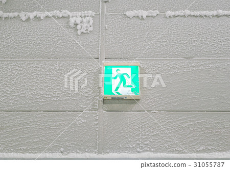 Fire escape sign covered with snow . Fire escape sign covered with snow . 31055787