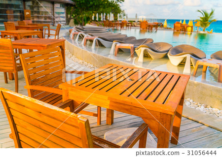 Table and chairs at restaurant in tropical Maldives island . Table and chairs at restaurant in tropical Maldives island . 31056444