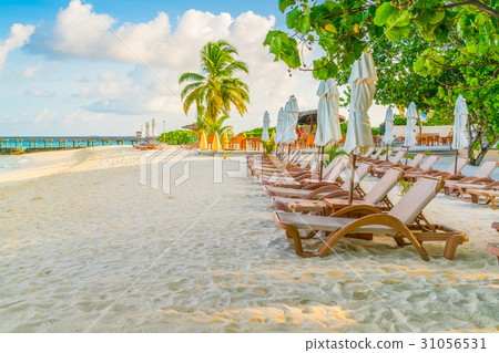Beach chairs with umbrella at Maldives island, white sandy beach and sea . 31056531
