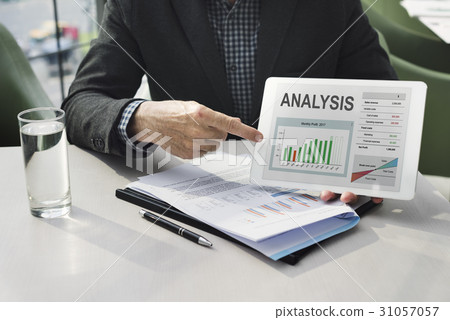 Hands working on digital device network graphic overlay 31057057