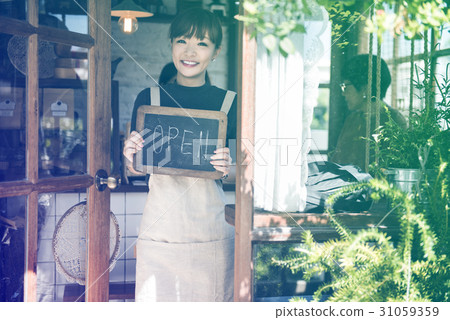 Young woman holding banner open the cafe 31059359