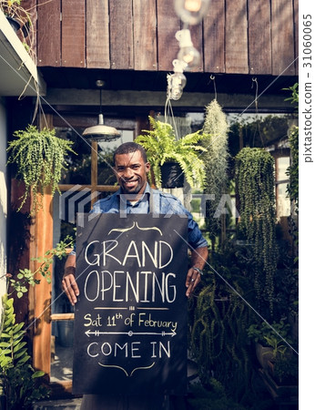 African Dscent Man Carrying Shop Grand Opening Board Announcemen 31060065