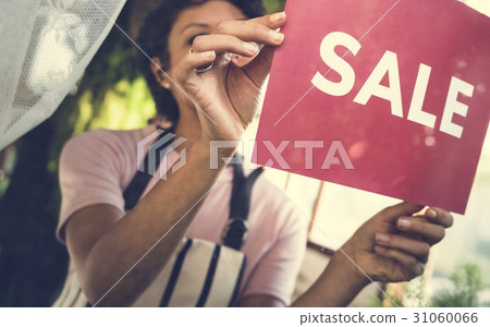 People Put Up Sale Sign by the Glass 31060066