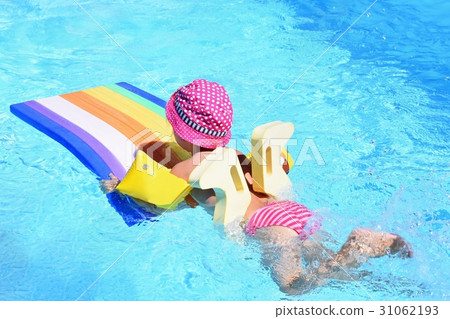 Little baby girl swims on the lilo in water. Little baby girl swims on the lilo in water. 31062193