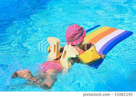 Little baby girl swims on the lilo in water. Little baby girl swims on the lilo in water. 31062195