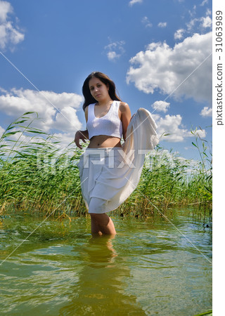 Pretty woman in white suit in water Pretty woman in white suit in water 31063989