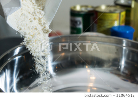 pouring the flour into the stainleass blow 31064512