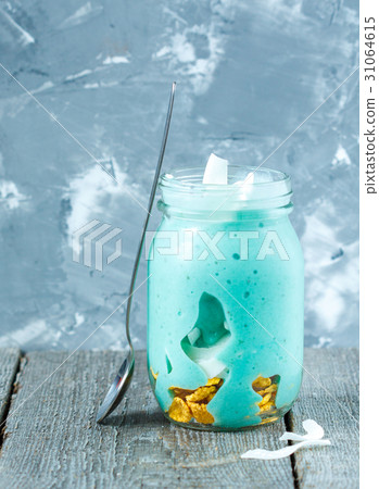 Blue tropical smoothie with coconut in a jar. Blue tropical smoothie with coconut in a jar. 31064615