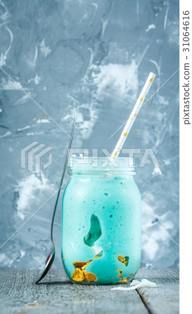 Blue tropical smoothie with coconut in a jar.  31064616
