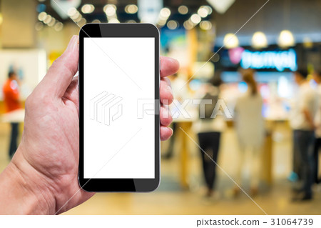 One trying smartphone in IT shop One trying smartphone in IT shop 31064739