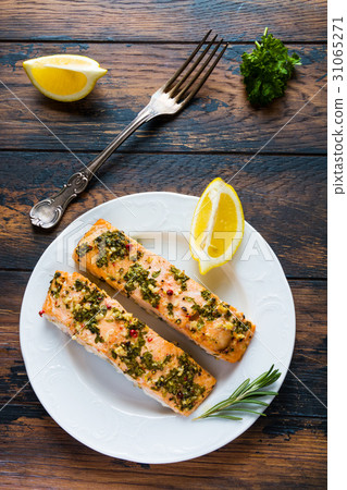 Salmon roasted in an oven with a butter, parsley Salmon roasted in an oven with a butter, parsley 31065271