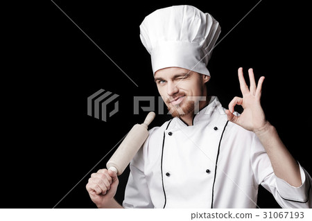 Young bearded man chef In white uniform holds 31067193