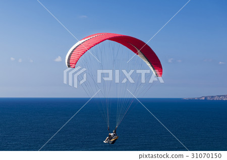 Paragliding in blue cloudy sky 31070150