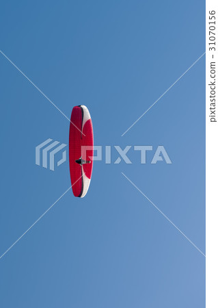 Paragliding in blue cloudy sky Paragliding in blue cloudy sky 31070156