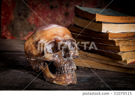 Still Life with a Skull and book on wooden table 31070515