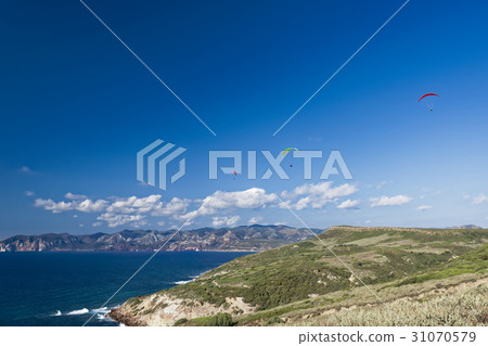 Paragliding in blue cloudy sky Paragliding in blue cloudy sky 31070579