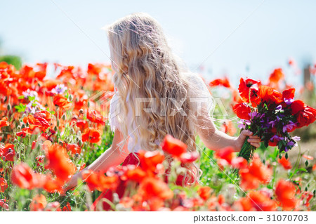Pretty child girl with bouquet of red poppies and 31070703