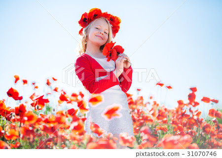 Happy blonde child girl in poppy field Happy blonde child girl in poppy field 31070746