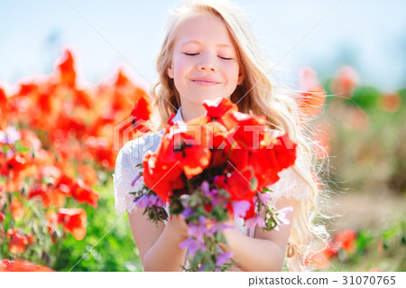 Pretty child girl with bouquet of poppies Pretty child girl with bouquet of poppies 31070765
