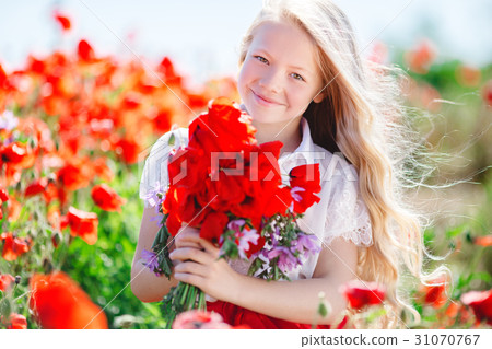 Pretty child girl with bouquet of poppies Pretty child girl with bouquet of poppies 31070767