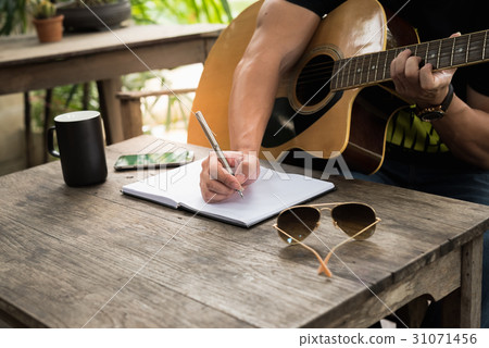 man compose song and play guitar 31071456