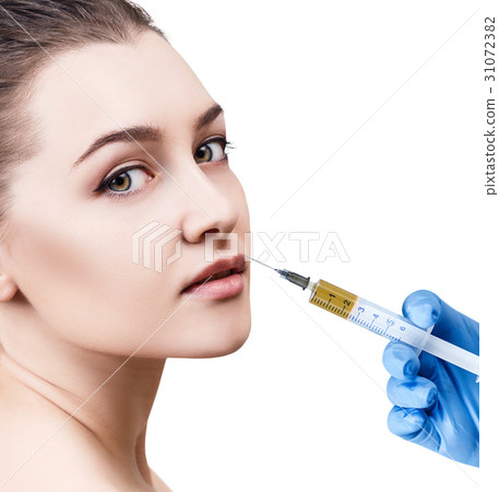 Beautiful woman gets injection in her lips. Beautiful woman gets injection in her lips. 31072382