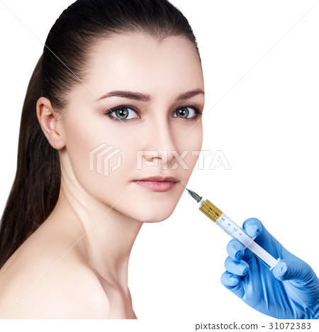 Beautiful woman gets injection in her lips. 31072383