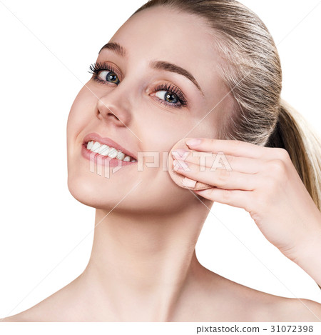 Young woman using cosmetics sponge. 31072398