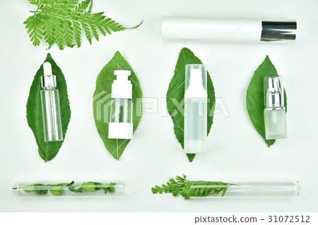 Cosmetic bottle container with green herbal leaves Cosmetic bottle container with green herbal leaves 31072512