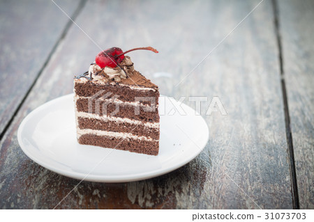 chocolate cake with cherry topping in outdoor cafe 31073703