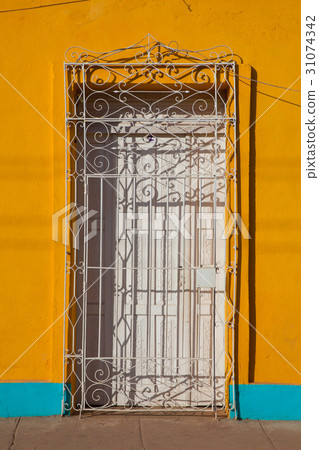 Typical colonial building with door iron grate Typical colonial building with door iron grate 31074342