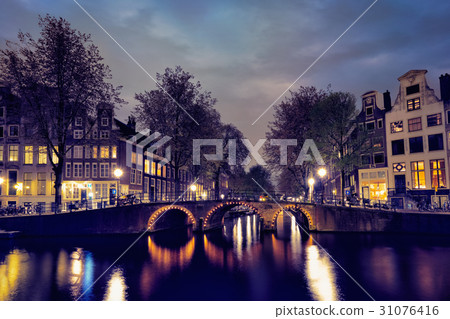 Amterdam canal, bridge and medieval houses in the Amterdam canal, bridge and medieval houses in the 31076416