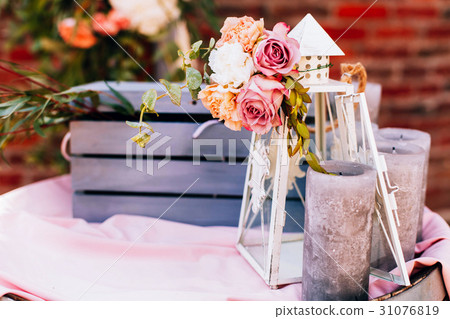 White lantern and black candles stand before  31076819