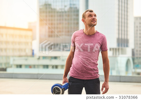 Young man holding gyroscooter. Young man holding gyroscooter. 31078366