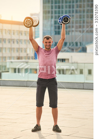 Man holding gyroboards and smiling. 31078390